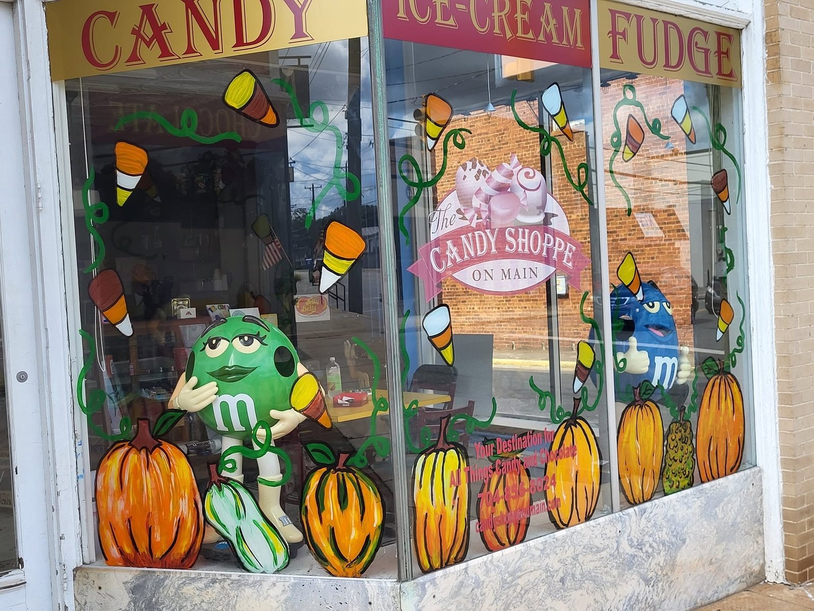 Hand-painted seasonal window art at The Candy Shoppe on Main
