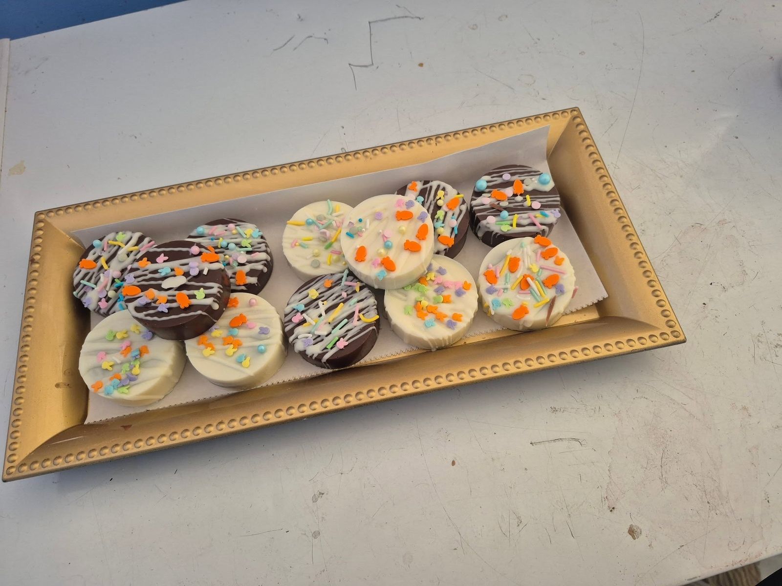Decorated chocolate-covered cookies in a gift tray at The Candy Shoppe on Main