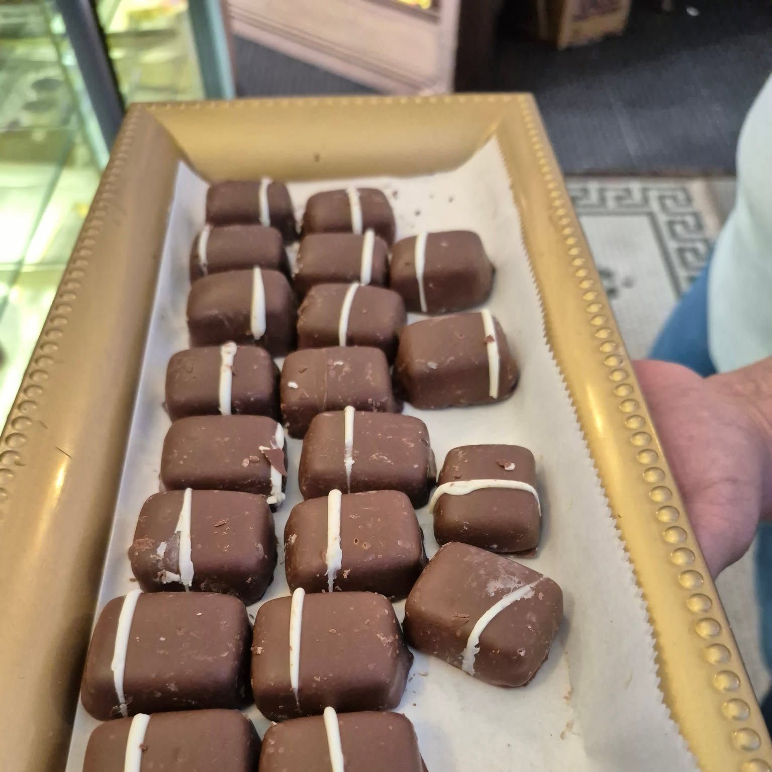 Chocolate-covered treats stacked in the display case at The Candy Shoppe on Main