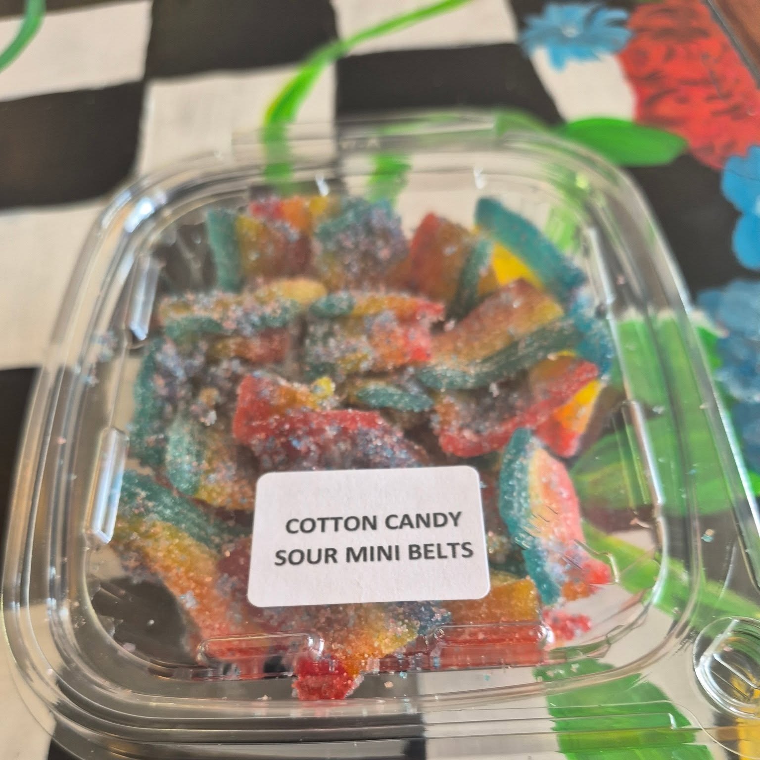 Tub of cotton candy sour mini belts at The Candy Shoppe on Main