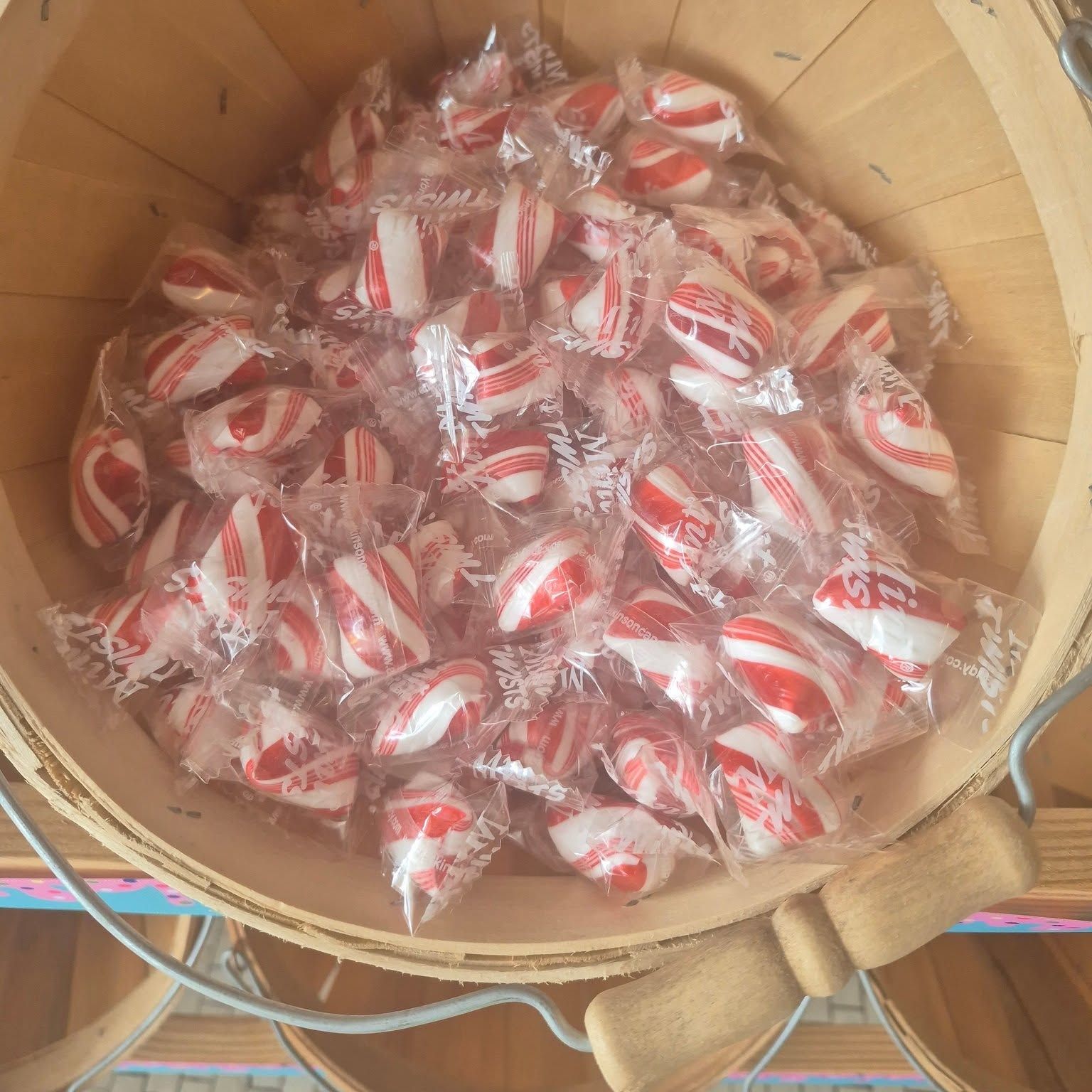 Wrapped peppermints filling a basket at The Candy Shoppe on Main