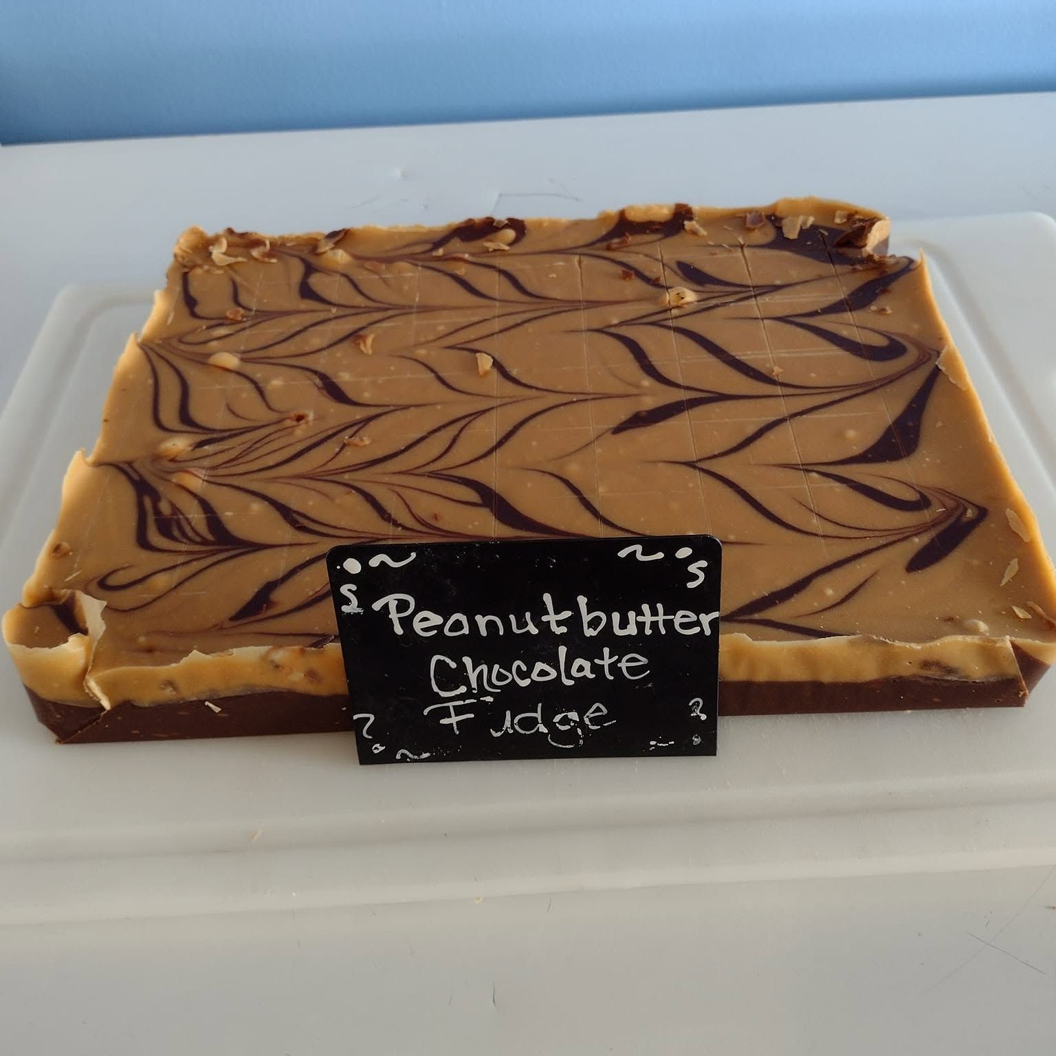 Peanut butter chocolate fudge slab labeled in the case at The Candy Shoppe on Main