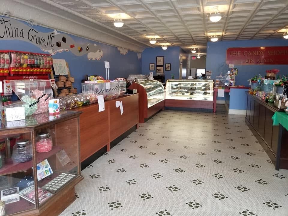 Display cases and candy shelves lining the room inside The Candy Shoppe on Main