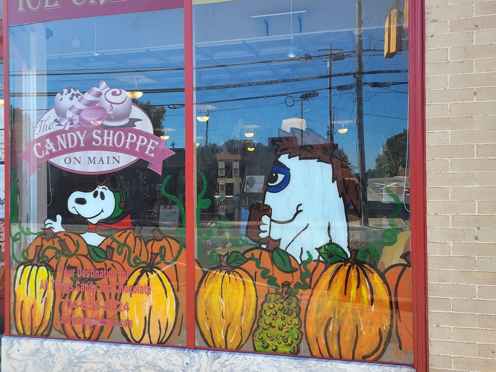Hand-painted autumn window art on the front window of The Candy Shoppe on Main