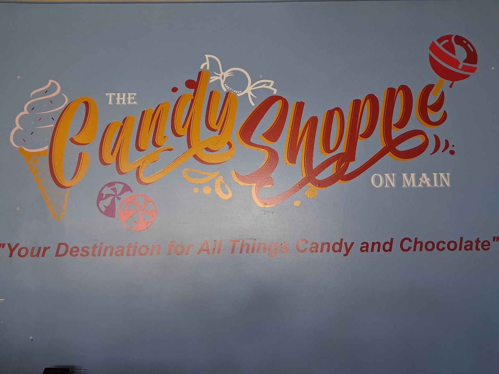 The Candy Shoppe on Main logo hand-painted on the wall inside the shop