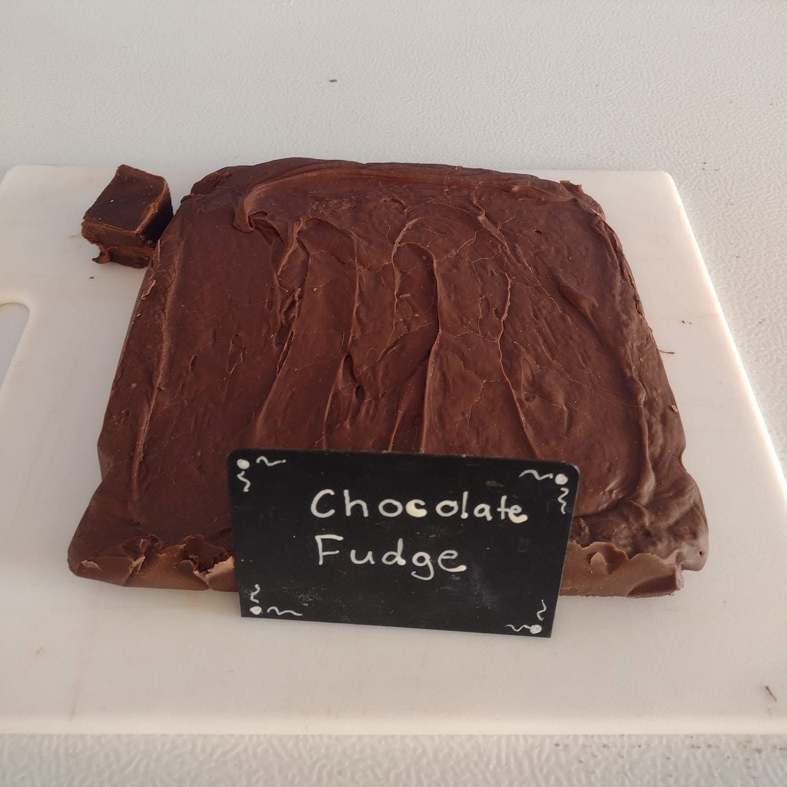 Chocolate fudge slab labeled in the case at The Candy Shoppe on Main