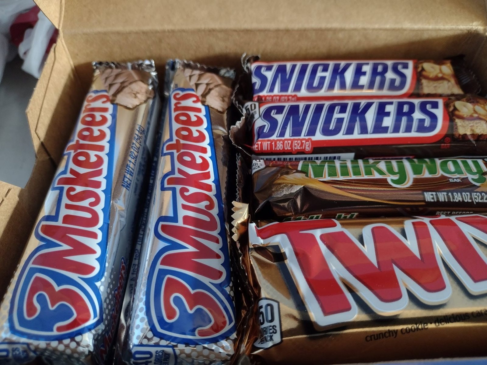 Boxes of Snickers, 3 Musketeers, Milky Way, and Twix bars at The Candy Shoppe on Main