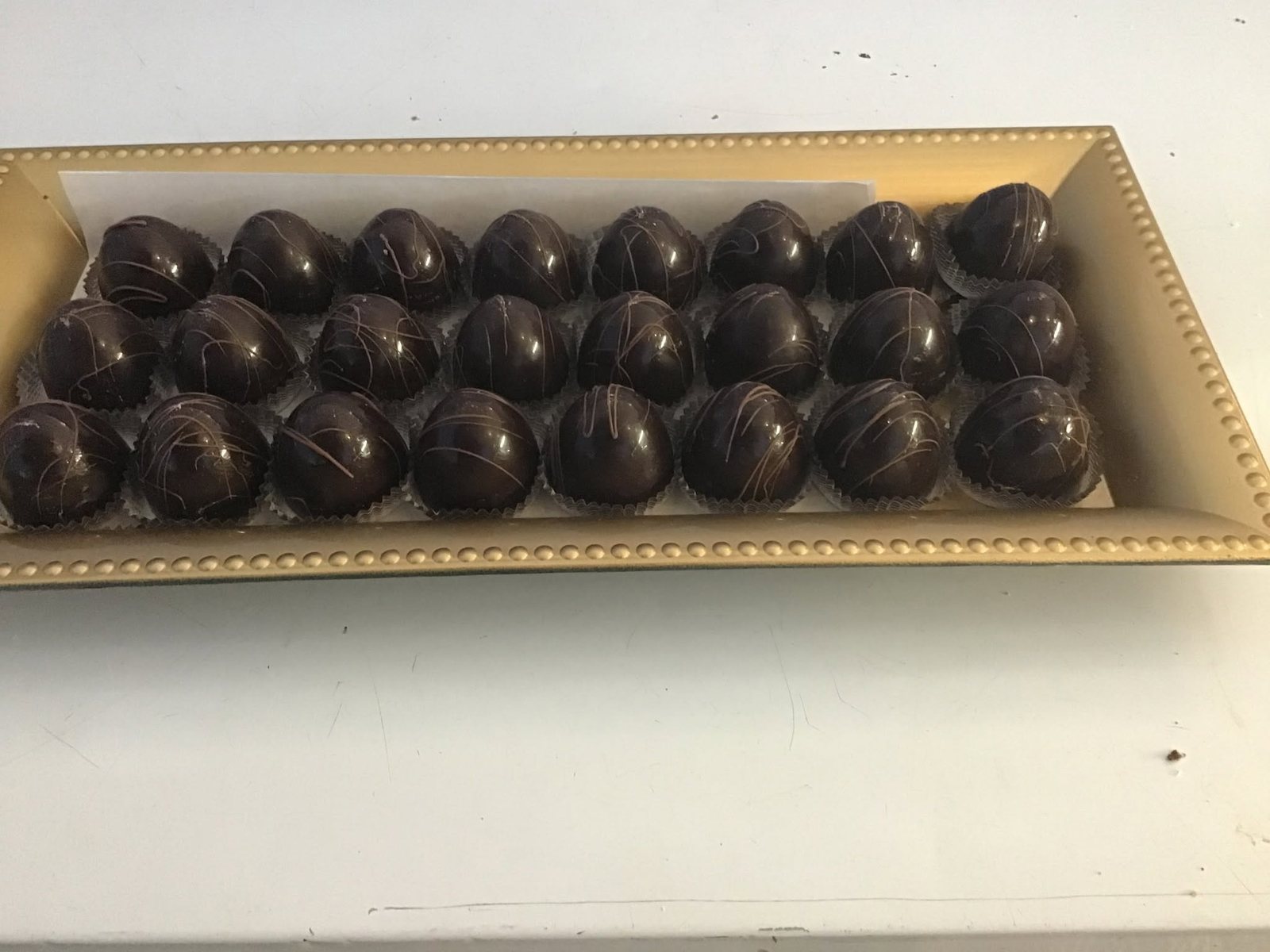 Rows of chocolate truffles on a tray at The Candy Shoppe on Main