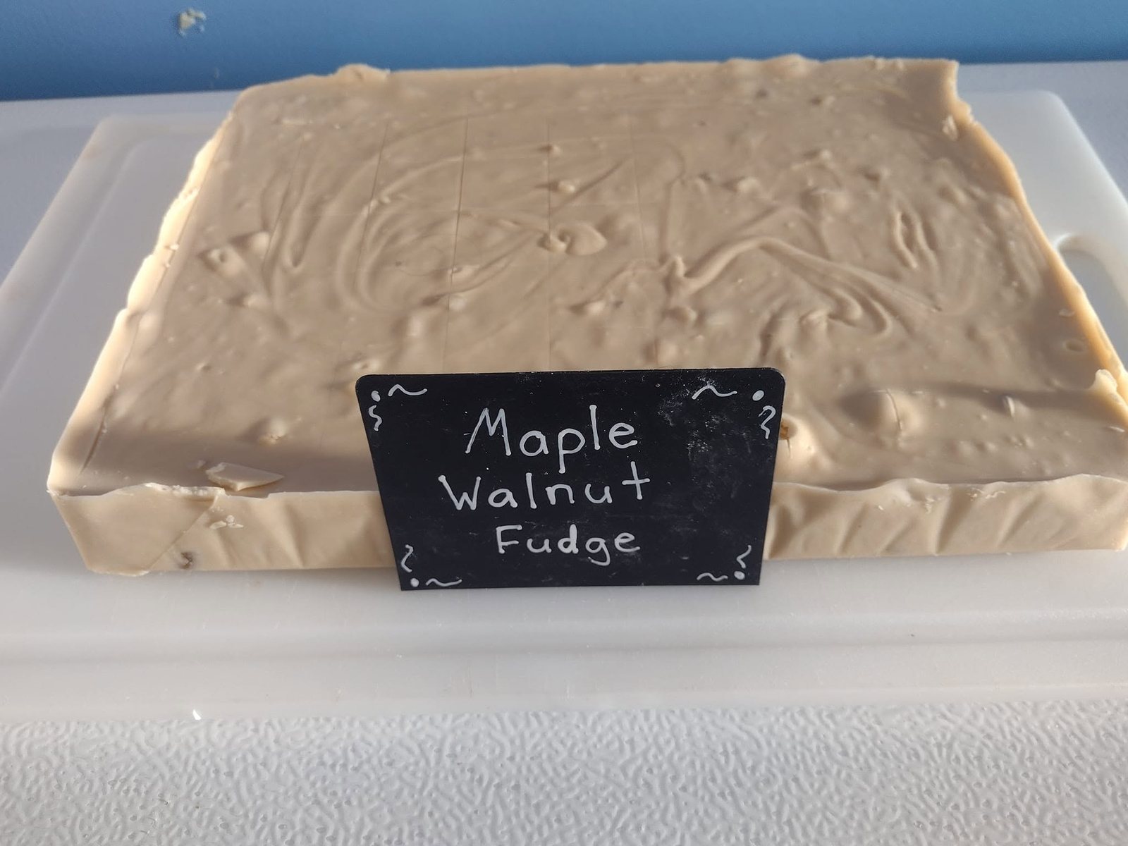 Maple walnut fudge slab with its chalk label at The Candy Shoppe on Main
