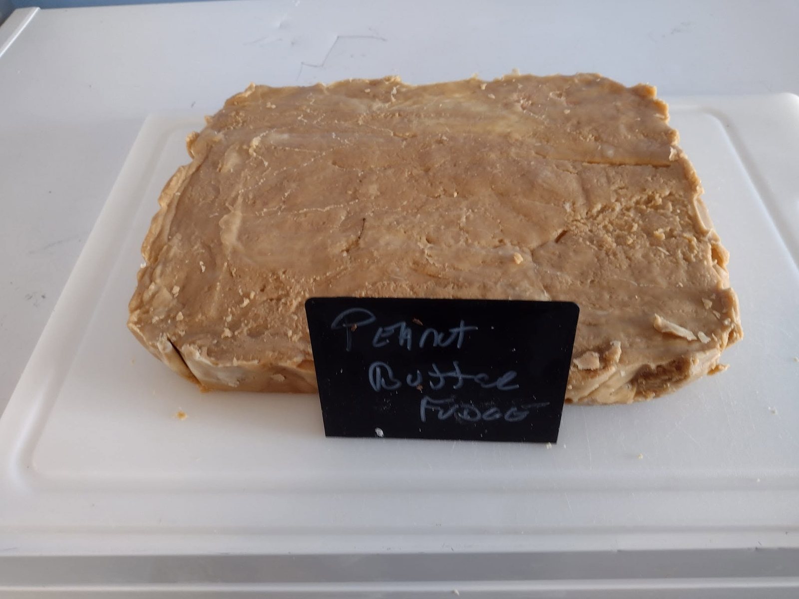 Peanut butter fudge slab labeled in the case at The Candy Shoppe on Main