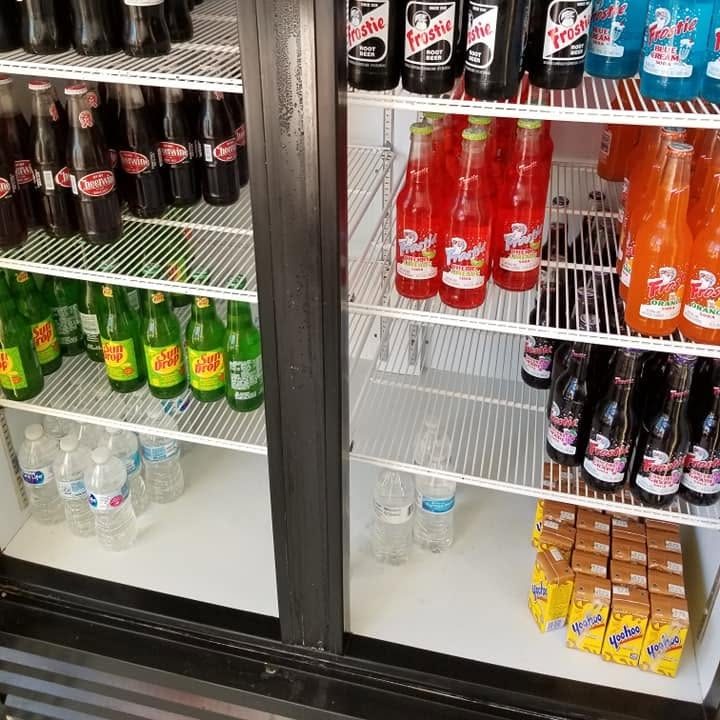 Sun Drop bottles chilling with the other glass sodas in the cooler at The Candy Shoppe on Main