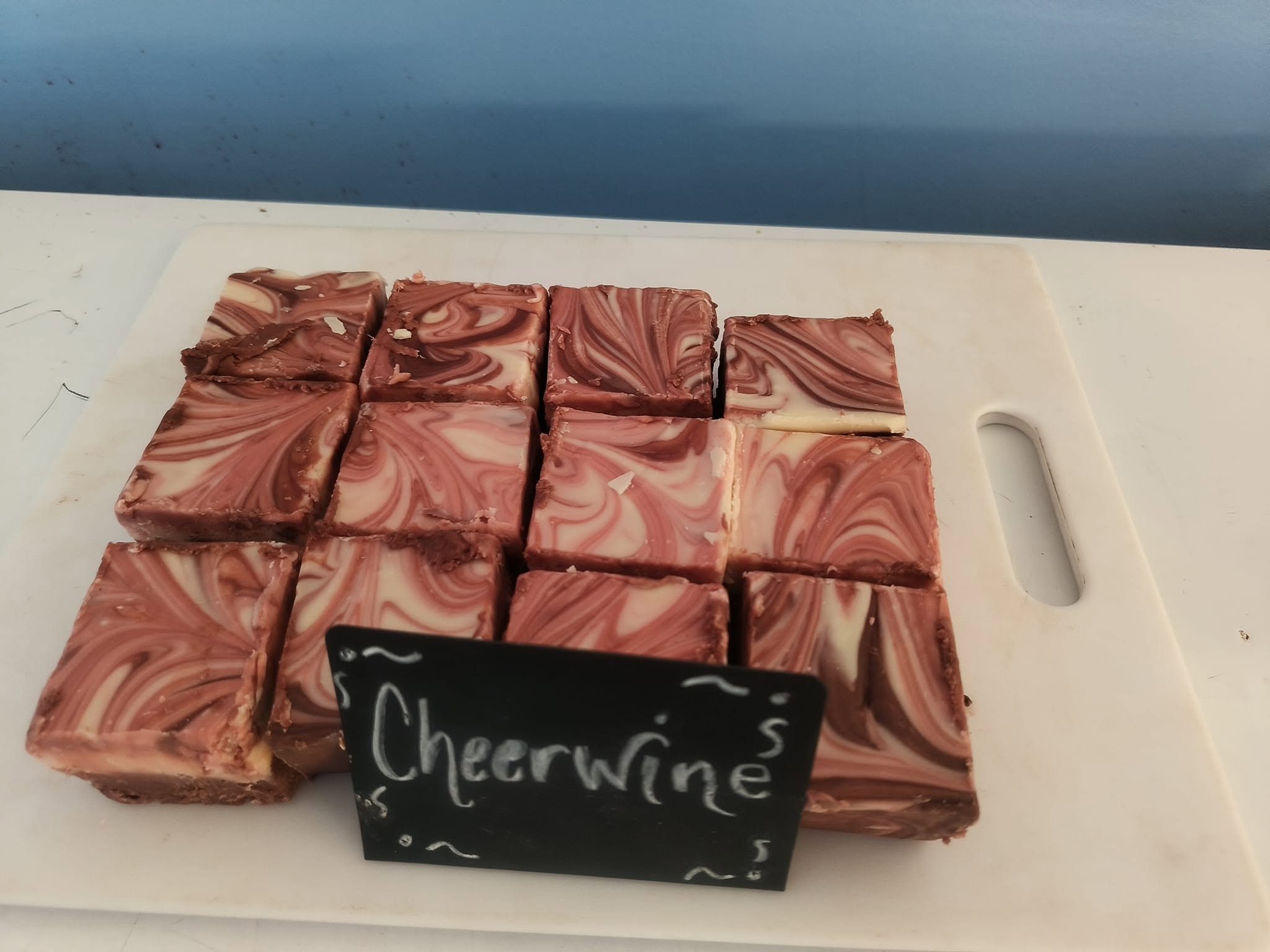 Cheerwine fudge cut into squares in the case at The Candy Shoppe on Main