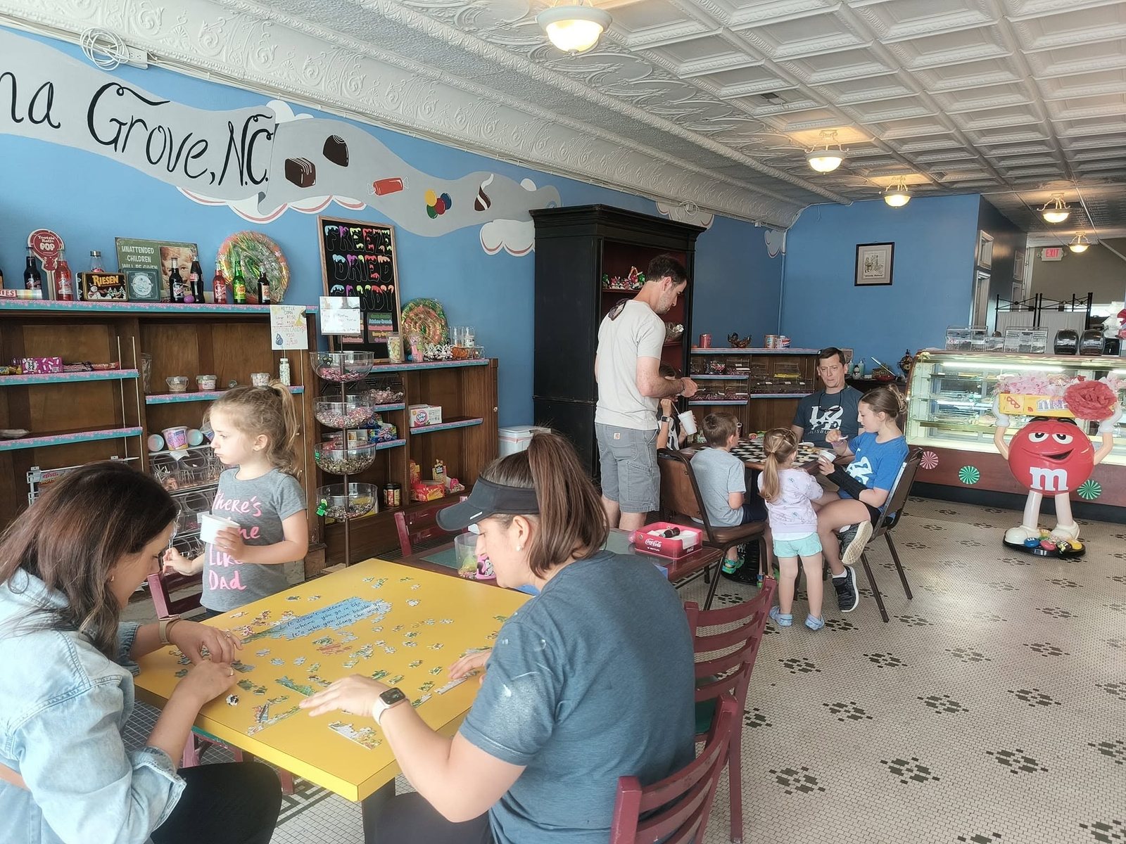Candy shelves lining the room inside The Candy Shoppe on Main